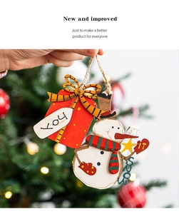 Macro detail of a wooden snowman and red gift box hanging ornament for Christmas trees