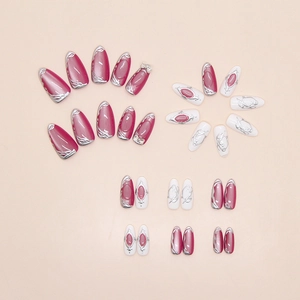 Macro view of long almond cat-eye press-on nails with silver bow and rose red glitter