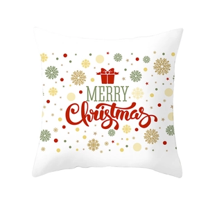 Macro shot of green Christmas pillow cover with snowflake patterns and Merry Christmas text