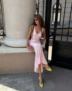 Detailed knit pattern of a pink crochet beach dress with elegant cut-out hollow texture