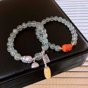 Detail view of S925 silver beaded bracelets with green phantom quartz and lotus charms