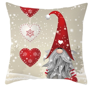 Close-up of Christmas gnome pillowcase featuring red hat and hanging heart ornaments