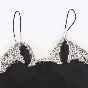 Close-up of contrast eyelash lace trim on V-neck black silk satin camisole top