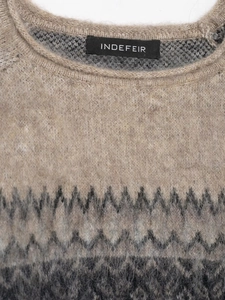 Close-up of beige and grey knit sweater with textured mohair feel and geometric jacquard