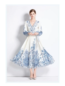 Detail of V-neck long-sleeve maxi dress featuring blue bohemian floral print and waist tie