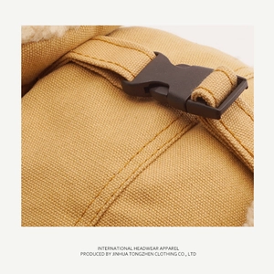Detailed macro shot of khaki canvas fabric, plastic buckle and white faux fur lining