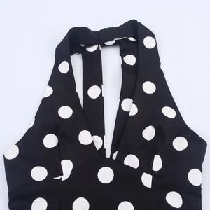 Polka dot halter neck top for women featuring a stylish bow detail and backless design