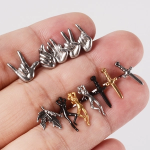 Macro shot of punk stainless steel stud earrings in silver gold and black finishes