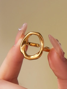 Macro shot of gold-plated stainless steel ring with organic molten lava texture