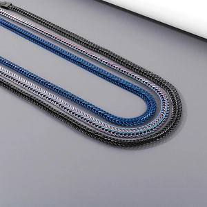 Detailed view of 9mm dragon bone chain necklaces in blue, black and rainbow titanium steel