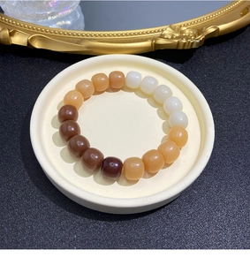 Close-up of natural weathered Bodhi seed beads in earthy tones on a ceramic plate
