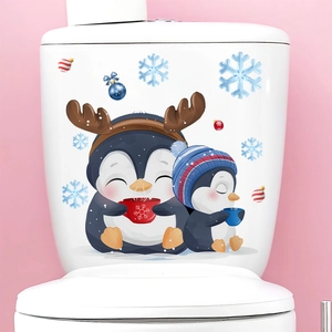 Detailed view of penguins and snowflakes Christmas decals on a white toilet