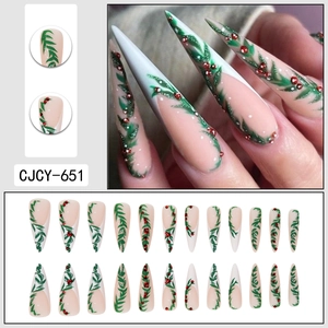 Christmas long stiletto press-on nails with green holly leaves and red rhinestones