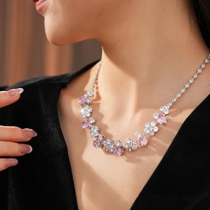 Close-up of floral crystal necklace with pink and white stones on female model
