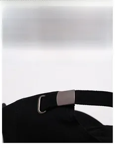 Detail of adjustable metal buckle and cotton fabric strap on the vintage baseball cap