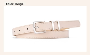 Detail view of beige skinny belt with polished silver buckle and dual metal loops
