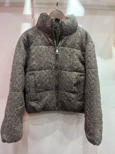 Detailed macro view of the dark grey thick knit texture and zip-up collar on the jacket
