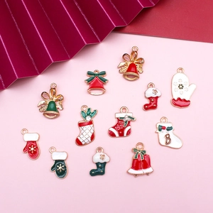 Detailed flat lay of 12 Christmas alloy charms including red and green bells and socks
