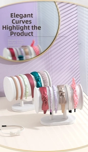 Close-up of assorted velvet headbands displayed on a white cylindrical storage stand