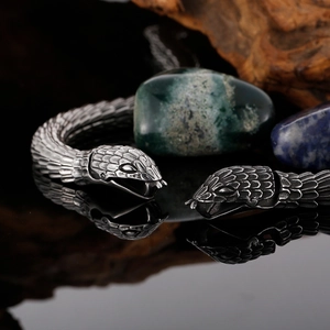 Close-up of vintage stainless steel snake bracelet featuring intricate scale textures