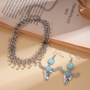 Bohemian silver jewelry set featuring bull head turquoise earrings and tassel necklace