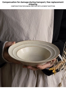 Close-up of handmade cream ceramic pasta bowl with wabi-sabi concentric textures