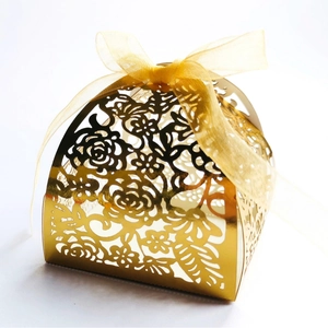 Laser cut golden wedding candy box with elegant hollow rose patterns and yellow ribbon bow