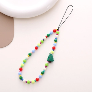 Detail of colorful beaded phone strap featuring a Christmas tree charm on a desktop