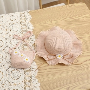 Pink straw sun hat and matching crossbody bag set with white daisy flower decorations