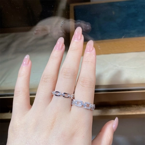 Detailed view of silver S925 stacking rings featuring V-shape pave zircon and chain style