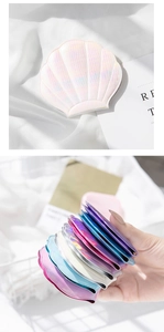 Detail of shell-shaped laser wallets with iridescent scale texture in multiple vibrant colors