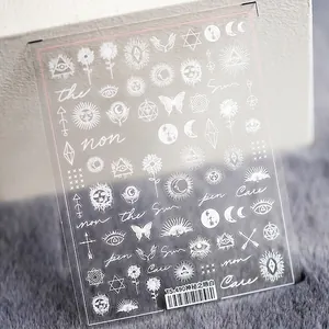 5D nail art stickers with white mystical symbols like sun, moon and eye on clear backing