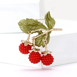 Close-up of alloy enamel blackberry brooch with red berries and golden green leaves