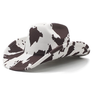Close-up of cowboy hat with realistic cow print texture and classic curved brim detail