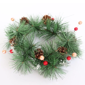 Christmas wreath with holly berries, pine cones and artificial snow for holiday decoration
