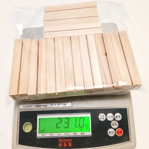 Detailed view of 10-piece wooden calendar bases being weighed for quality inspection