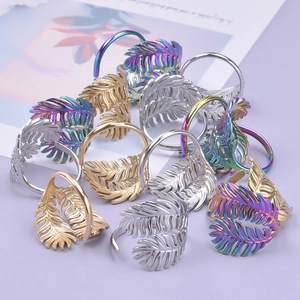 Detailed view of leaf wrap rings in gold, silver, and rainbow stainless steel finishes