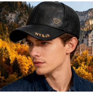 Close-up of black leather baseball cap featuring gold NY&JA embroidery and metal shield badge