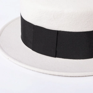Detail shot of the white wool felt fedora featuring a textured black grosgrain ribbon band