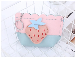 Detail of pink and blue strawberry coin purse with stitching and metal keychain