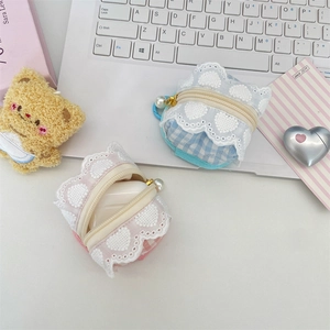 Detail of pink and blue checkered fabric earphone cases with lace trim and pearl zippers