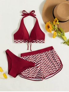 Detailed view of 3-piece burgundy swimsuit with halter top and chevron pattern shorts