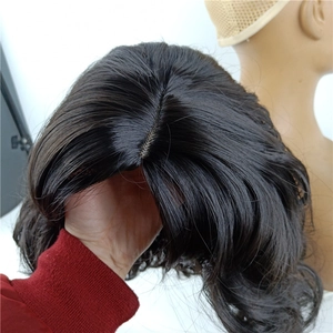 Detailed top view showing the realistic scalp part and curly black synthetic wig fiber