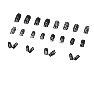 Short black shimmering press-on nails set with silver glitter stars and glossy finish