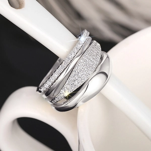 Macro shot of silver-plated layered ring featuring micro-pave cubic zirconia settings