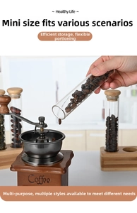 Detail showing coffee beans pouring from a glass test tube into a manual grinder