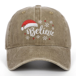 Close-up of Christmas embroidery with snowflakes and 'Believe' text on washed khaki cap