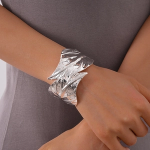Macro shot of a silver leaf-shaped open cuff bracelet with realistic vein textures