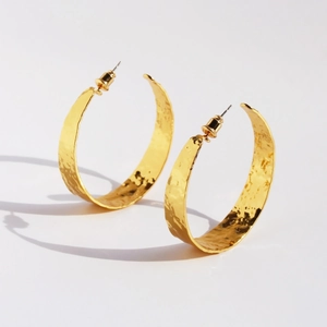 Golden C-shaped hoop earrings with unique hammered foil texture and vintage finish