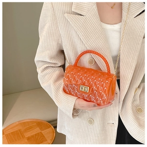 Detail of orange jelly bag with quilted pattern, gold chain and bead handle detail